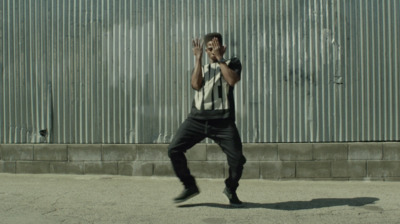 a man standing in front of a metal wall