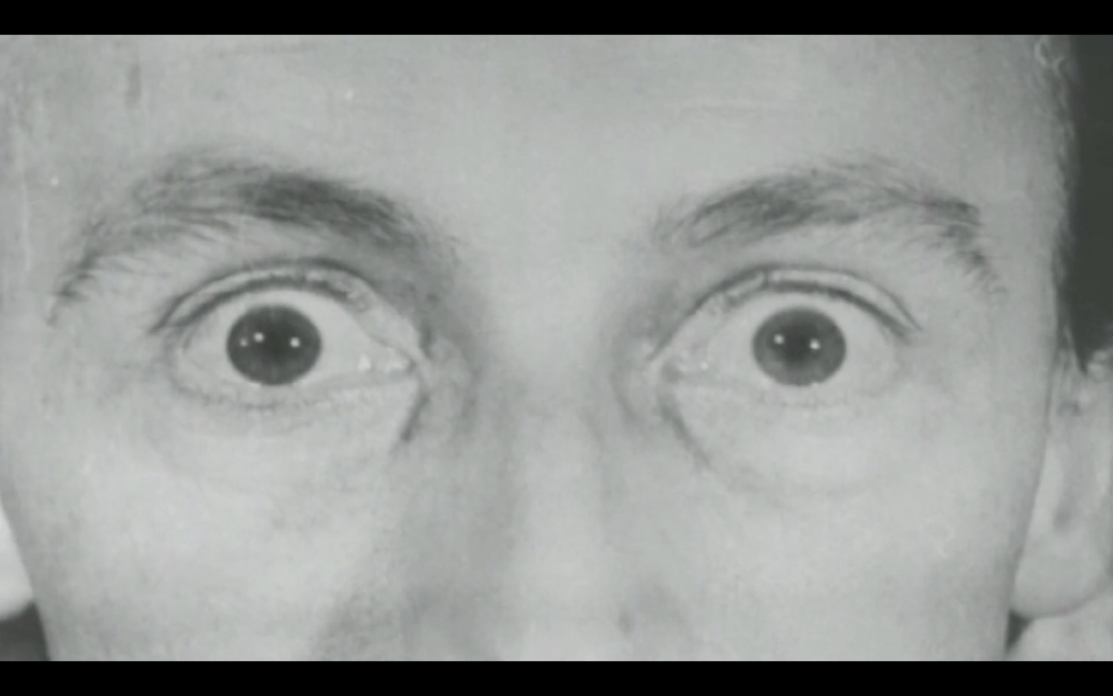 a black and white photo of a man's eyes