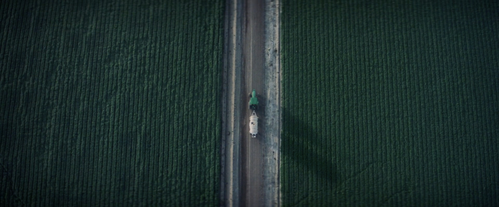 an aerial view of a car driving down a road