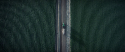 an aerial view of a car driving down a road