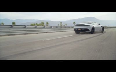 a white sports car driving down a highway