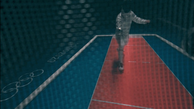 a man is playing tennis on a red and blue court