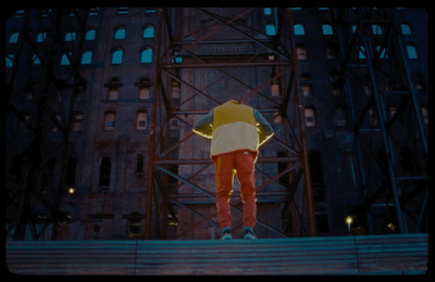 a man standing on a set of stairs in front of a tall building