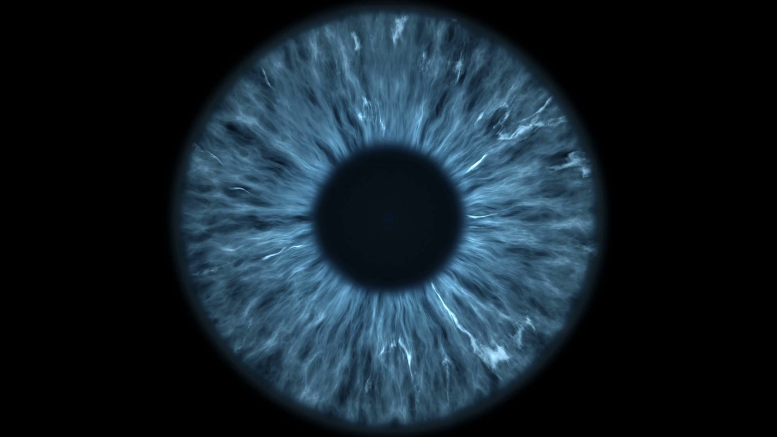 a close up of a blue eyeball in the dark