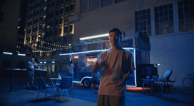 a man standing in front of a building at night