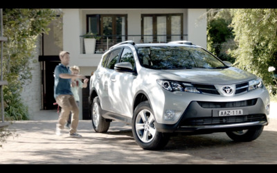 a man walking next to a white suv