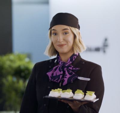 a woman is holding a tray of food