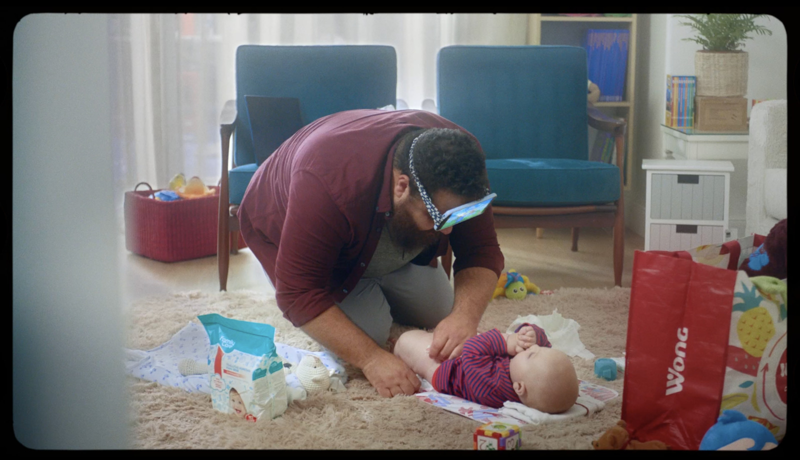 a man is playing with a baby on the floor