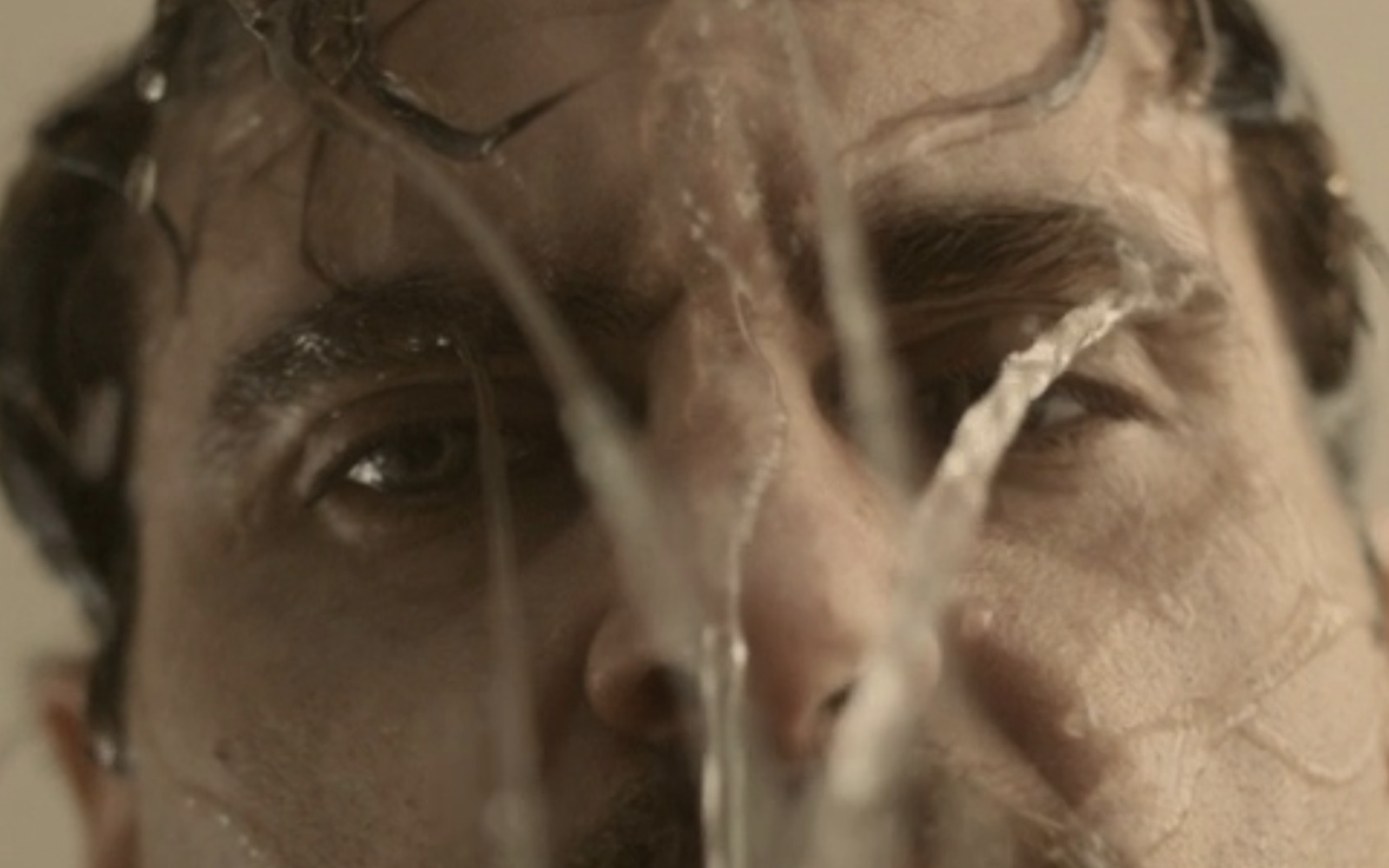 a close up of a man with water on his face