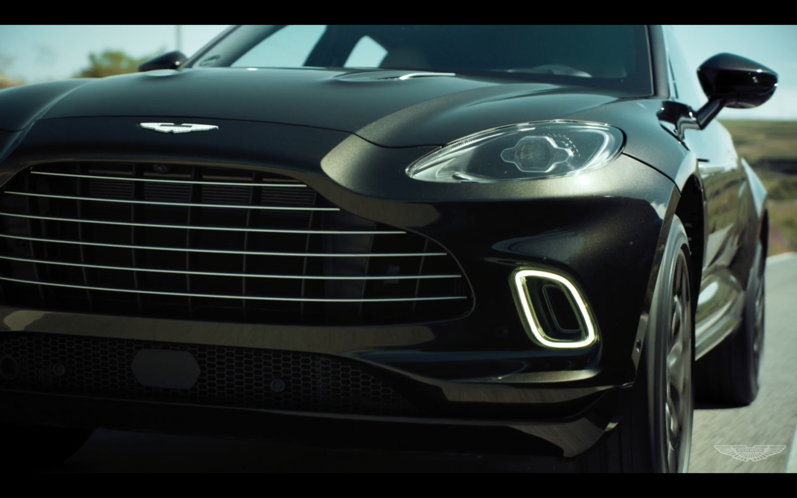 a close up of a black car on a road