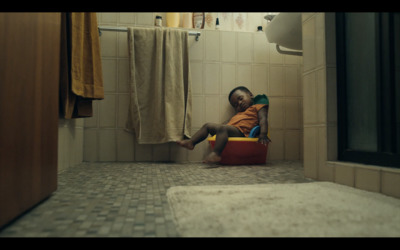 a small child is sitting on a potty in a bathroom