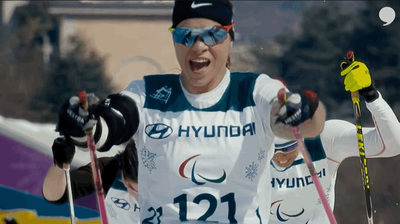 a woman in a white shirt holding skis and poles