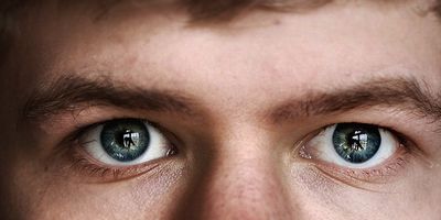 a close up of a person with blue eyes