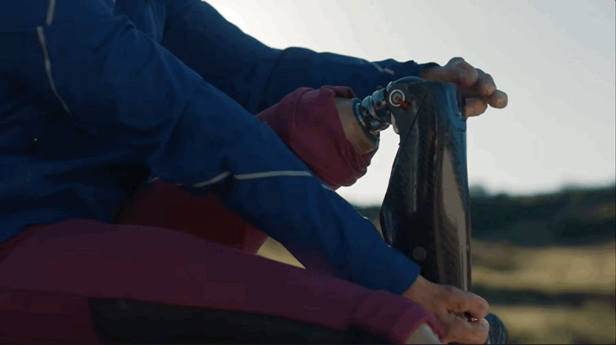 a person in a blue jacket holding a skateboard