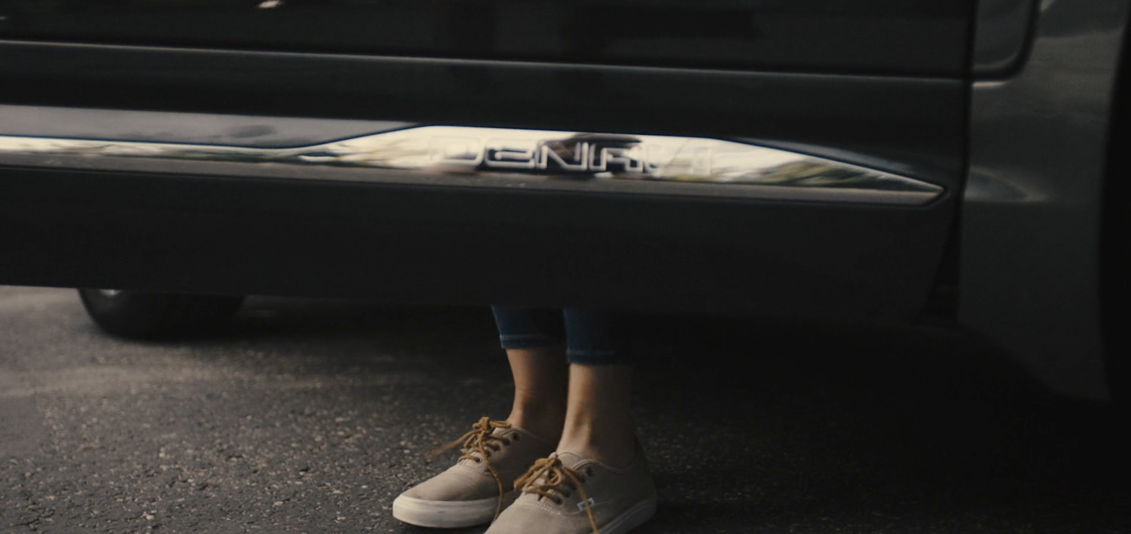 a close up of a person standing next to a car