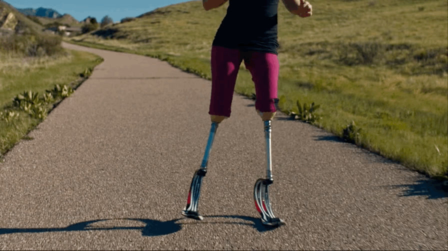 a woman riding on top of a scooter down a road