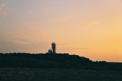 a radio tower sitting on top of a hill