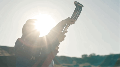 a person holding a large metal object in their hand