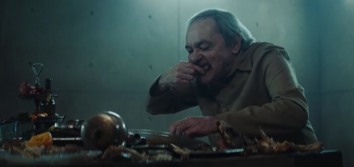 a man sitting at a table eating food