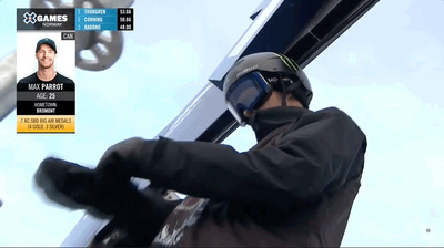 a man in a black jacket holding a snowboard