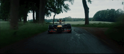 a race car driving down a country road