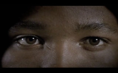 a close up of a person's face with a dark background