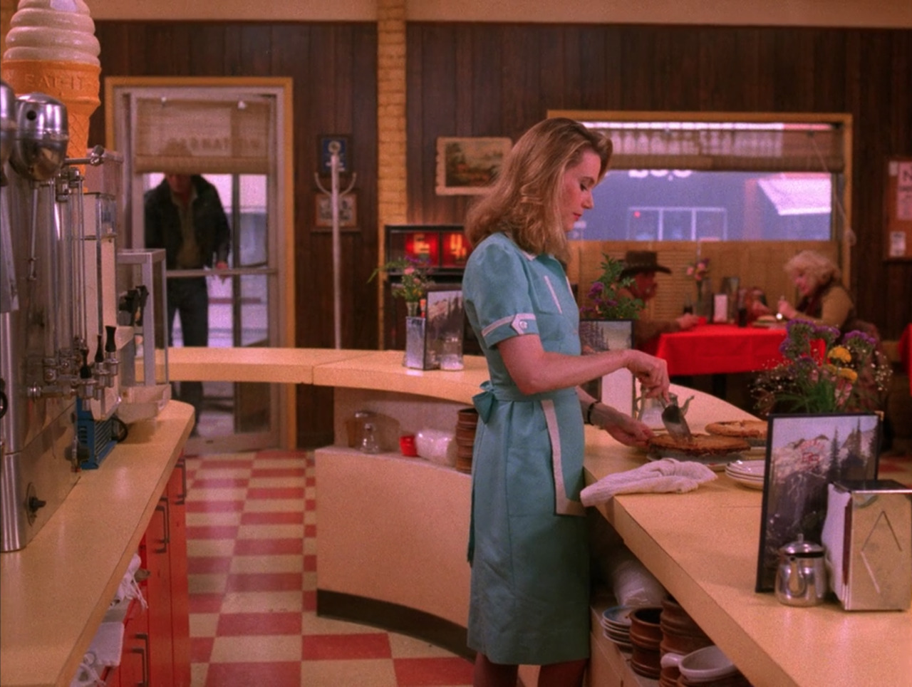 a woman standing in a kitchen preparing food