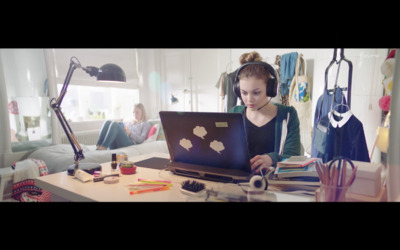 a woman sitting in front of a laptop computer