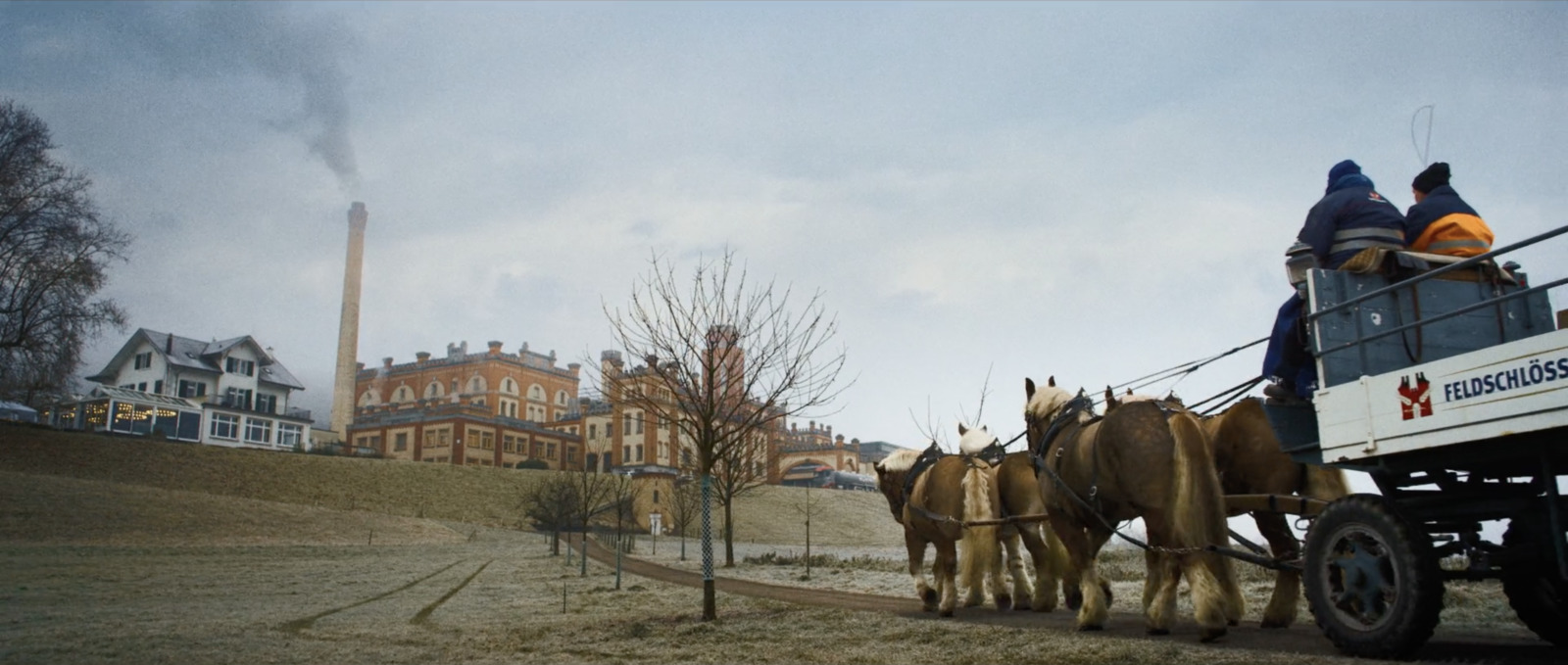 a group of people riding on the back of a horse drawn carriage