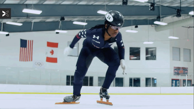 a man riding a skateboard down a snow covered slope