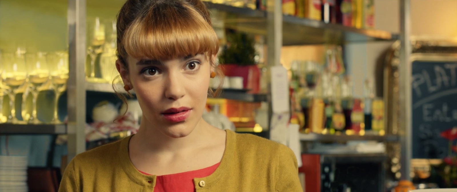 a woman with red hair standing in a store