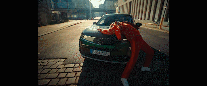 a person leaning on the hood of a car