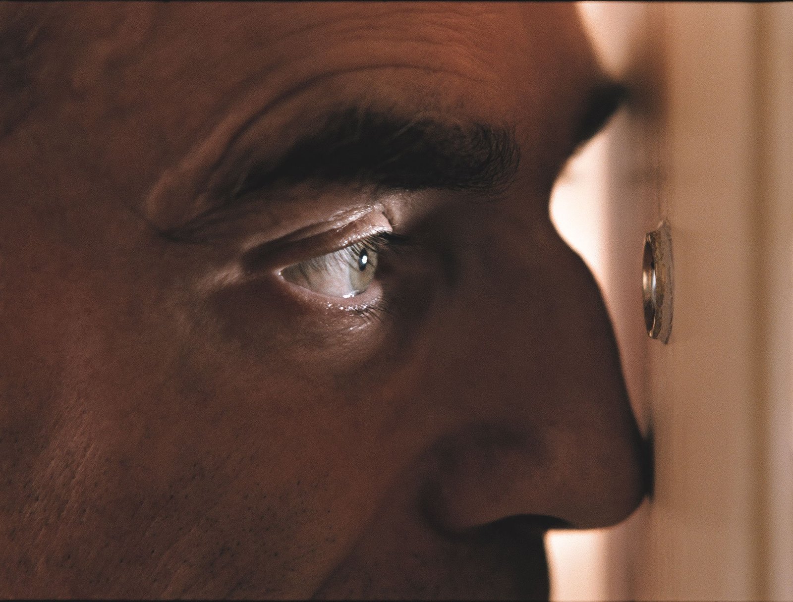 a close up of a man's face with a ring on his nose