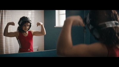 a woman in a red shirt brushing her hair