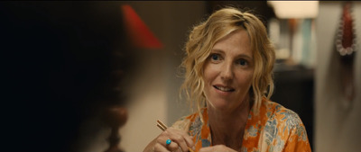 a woman sitting at a table with a plate of food