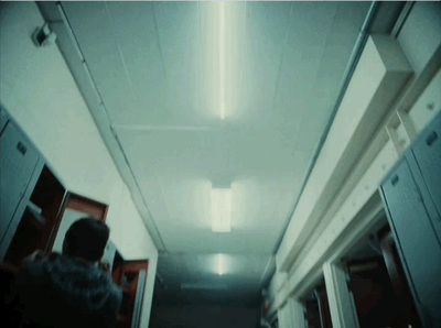 a person walking down a long hallway in a building