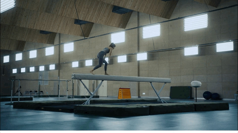 a man standing on a beam in a building