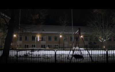 a building with a telescope in front of it at night