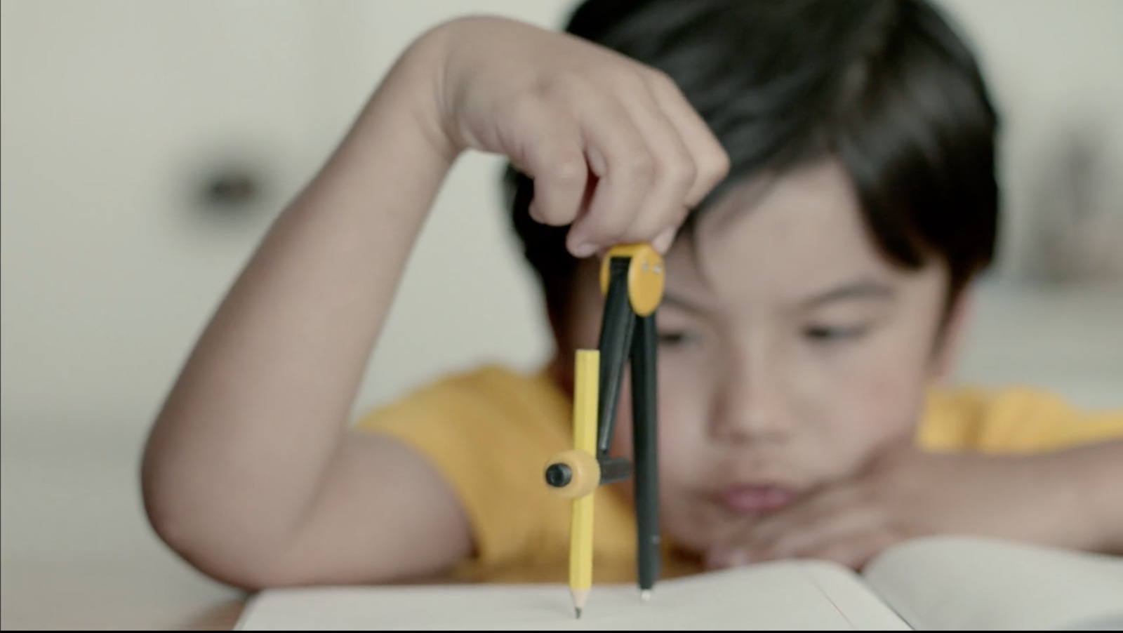 a little girl holding a pair of scissors over a book