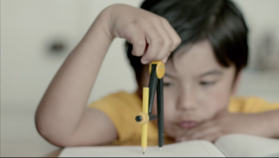 a little girl holding a pair of scissors over a book