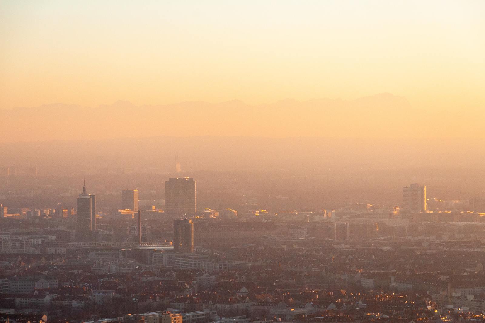 a view of a city at sunset with a hazy sky