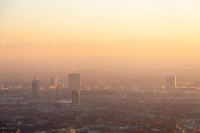 a view of a city at sunset with a hazy sky