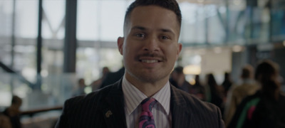 a man wearing a suit and a pink tie