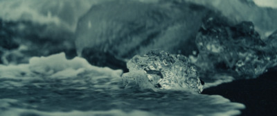 a rock in the middle of a body of water