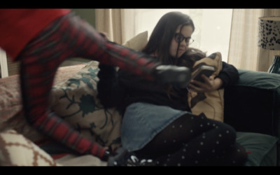 a woman sitting on a couch holding a remote control