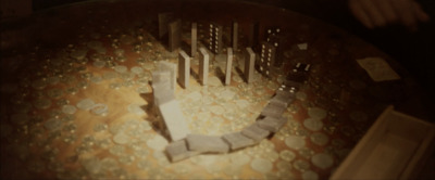 a wooden table topped with lots of coins