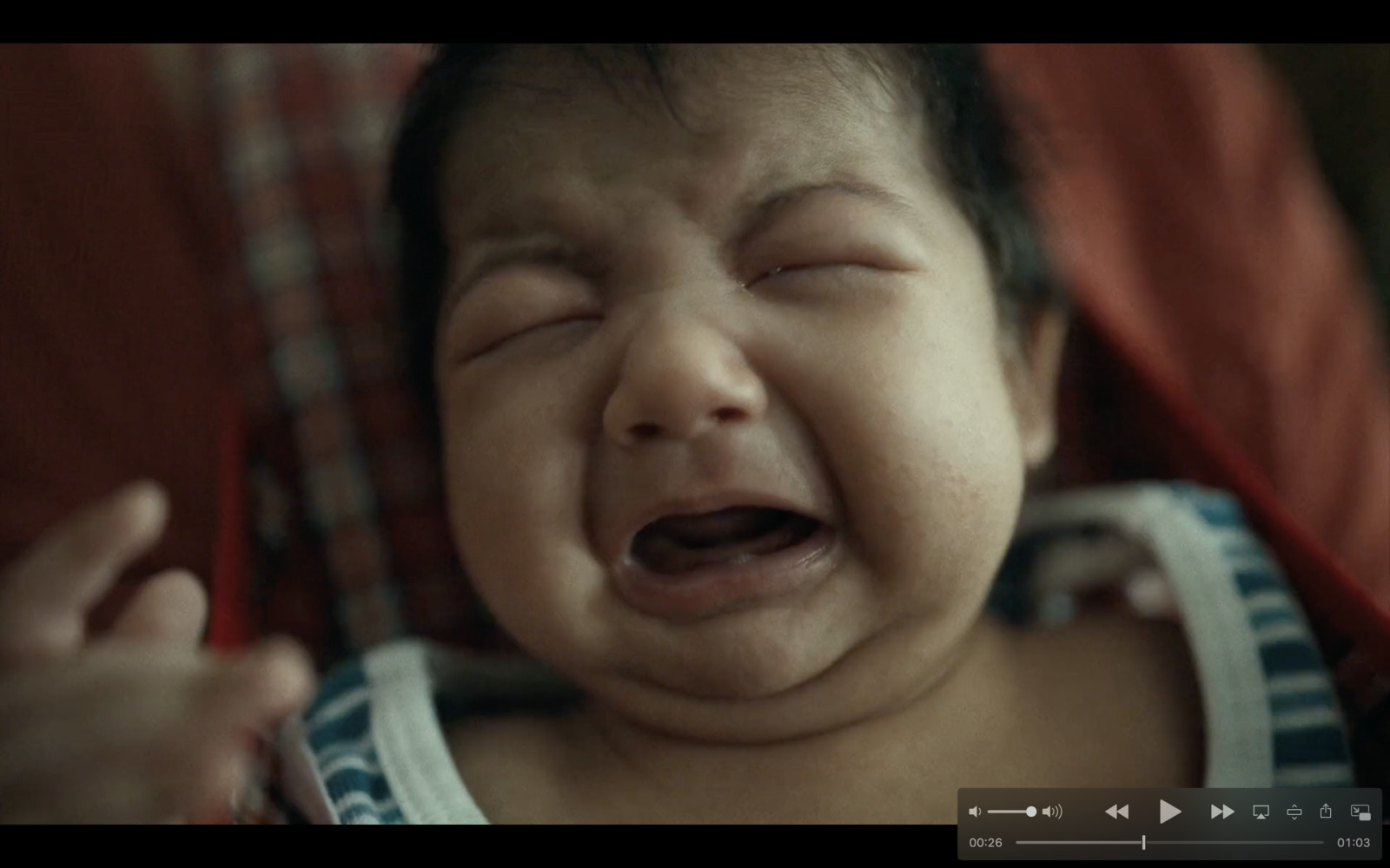 a baby crying while sitting in a car seat