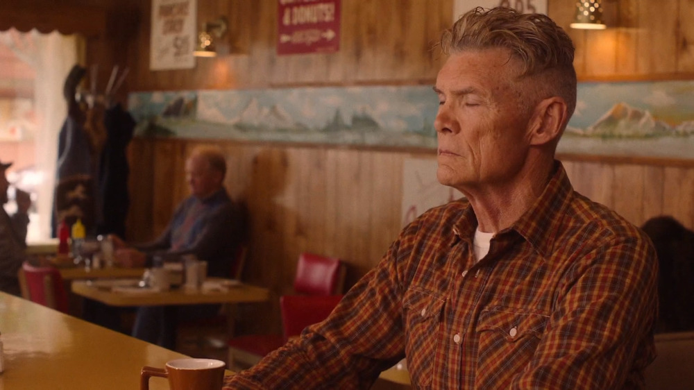 a man sitting at a table in a restaurant