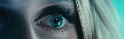 a close up of a woman's blue eye