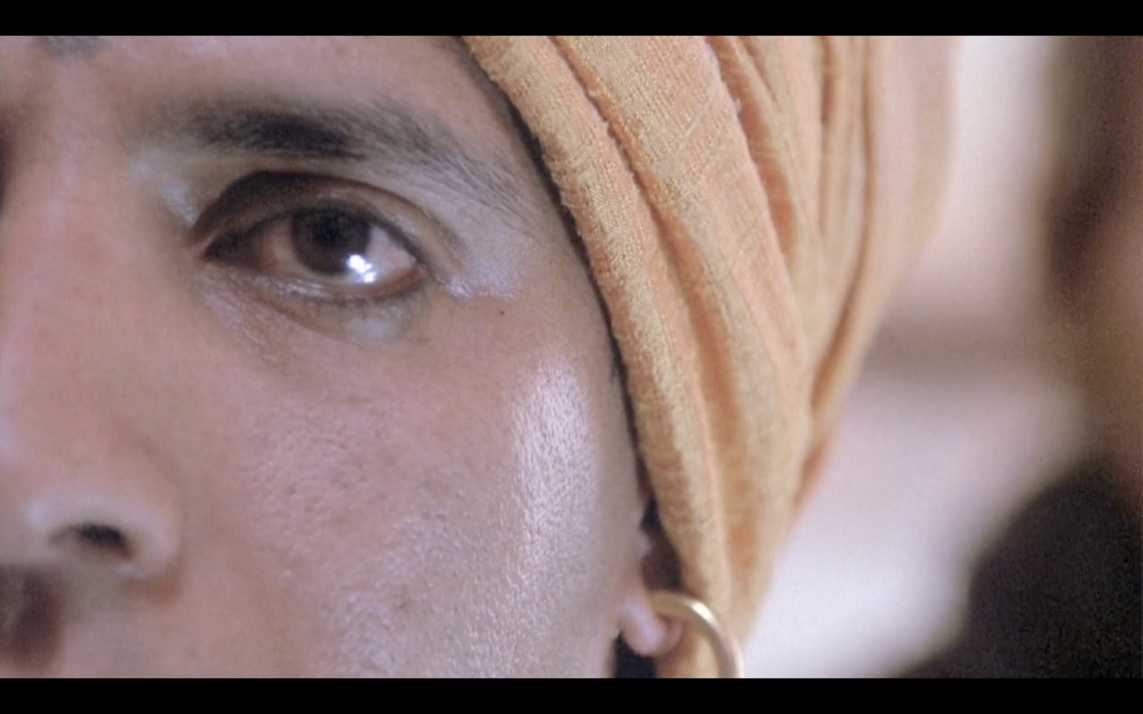 a close up of a man wearing a turban